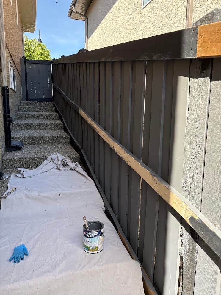 Side yard wooden fence during exterior repaint