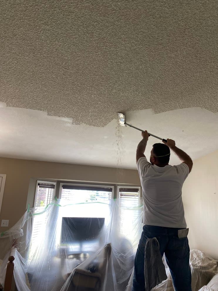 Popcorn ceiling removal with plastic protection and professional prep